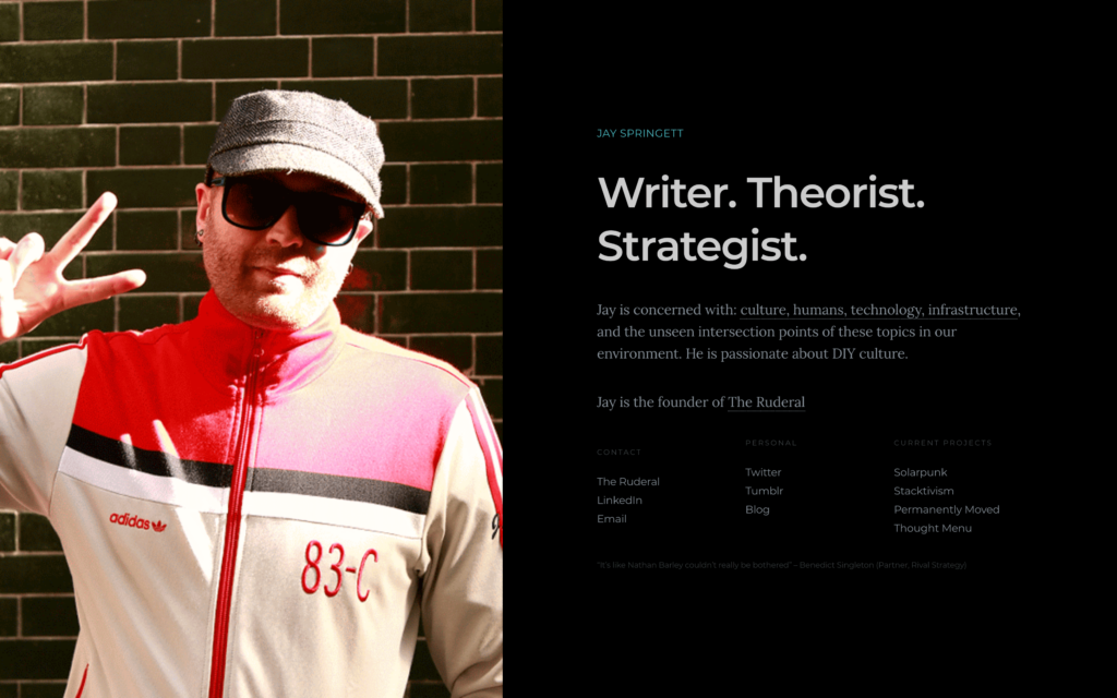 Screenshot of Jay Springett's personal website bio page showing his photo in a red Adidas tracksuit with the tagline "Writer. Theorist. Strategist." and links to projects