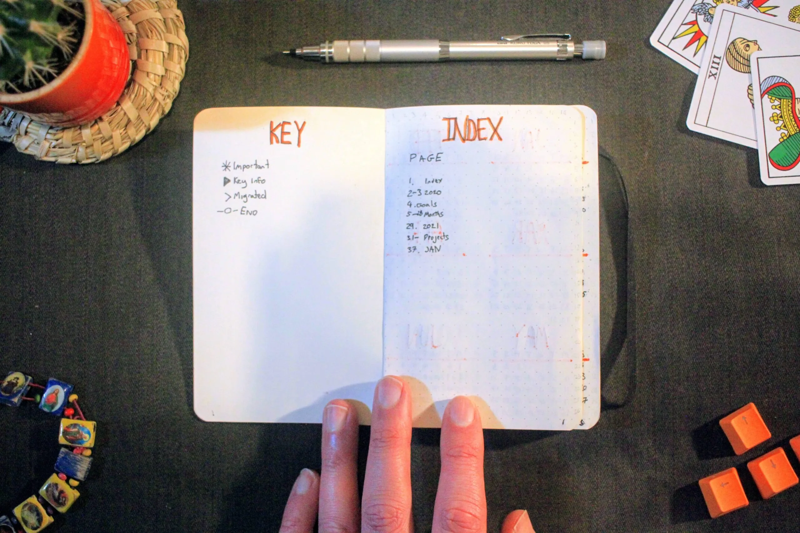 Open bullet journal showing KEY and INDEX pages with handwritten entries and page numbers