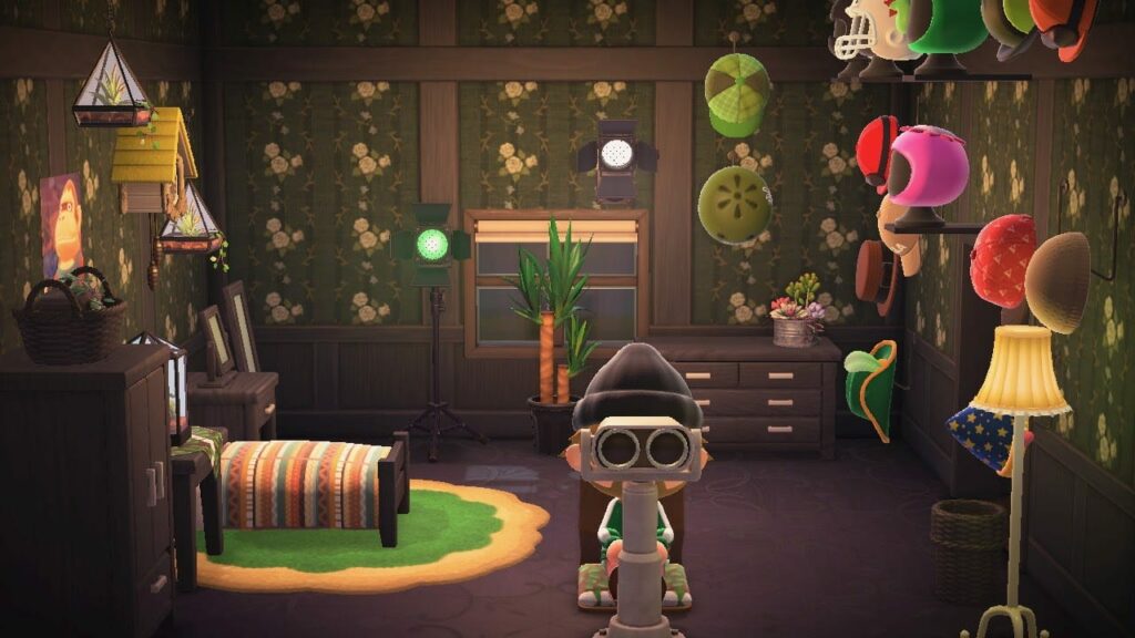 Character wearing goggles and hat in a jungle-themed room with hanging colorful objects, plants and wooden furniture