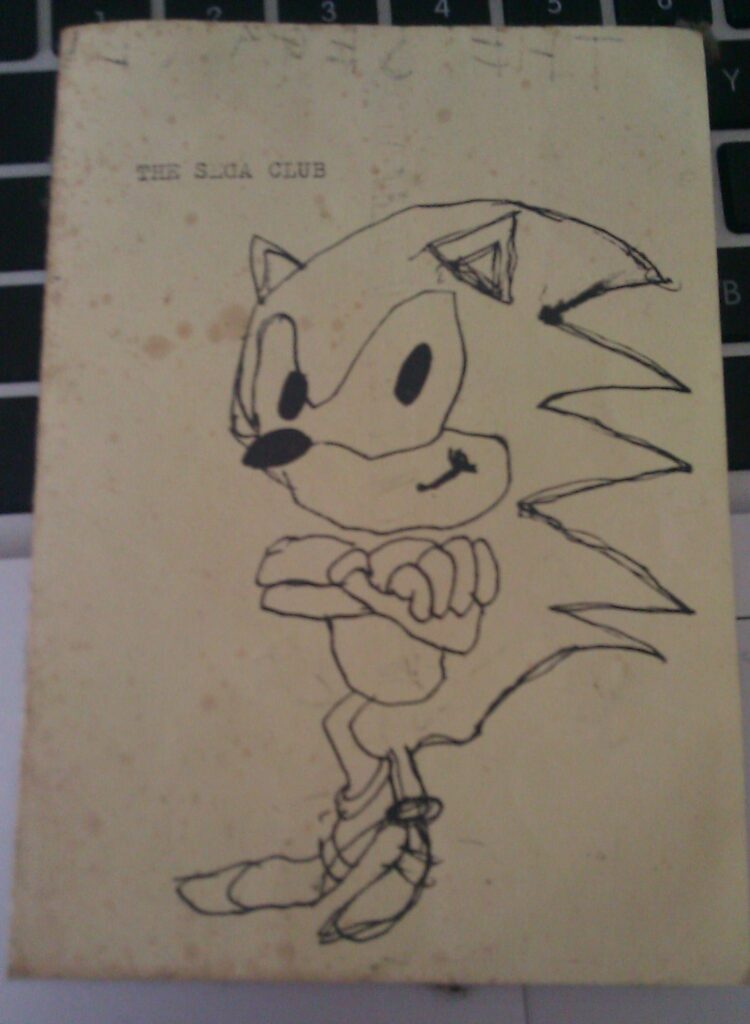 Zine cover of a hand-drawn sketch of Sonic the Hedgehog labeled The Sega Club on cream paper with ink. 1990's era fan art