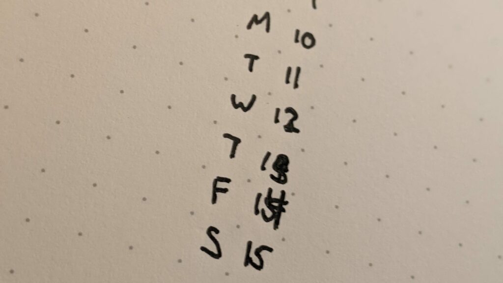 Handwritten day-of-week tracker with weekday abbreviations and checkboxes