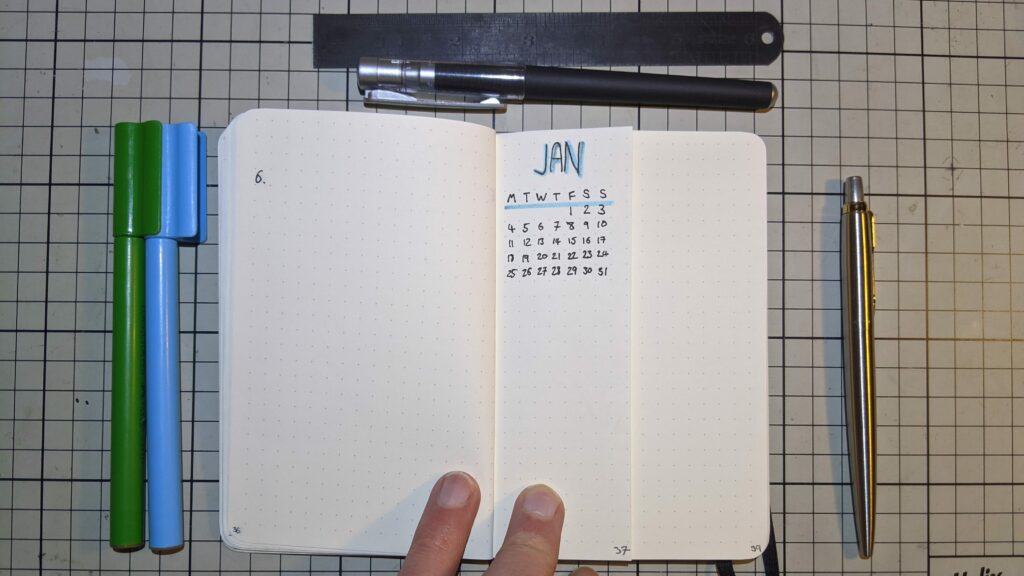 Handwritten January calendar page in bullet journal with grid layout