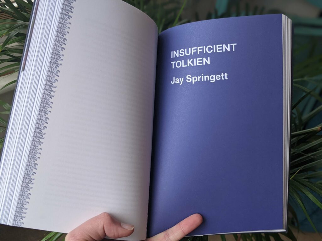 Hands holding open a book titled "Insufficient Tolkien" by Jay Springett, showing densely text-filled left page against green foliage background
