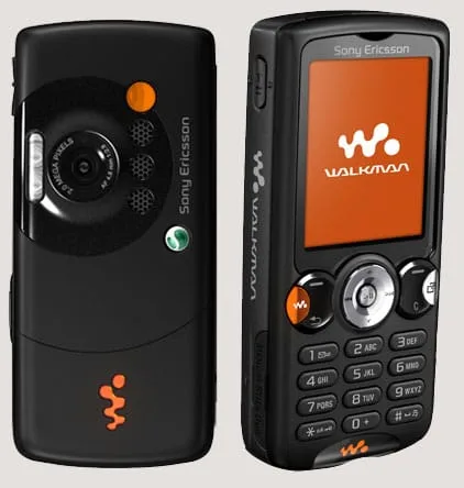 Two Sony Ericsson W810i mobile phones in black with orange accents showing camera and Walkman music player interfaces