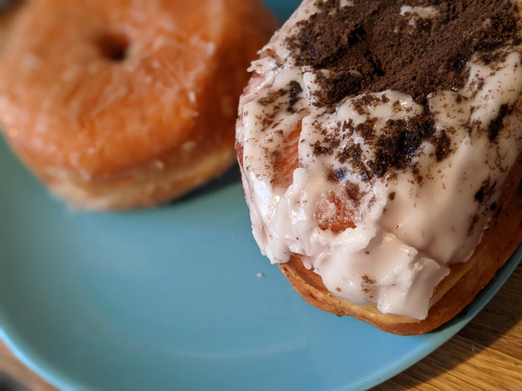 Frosted desserts topped with cocoa powder on a blue plate