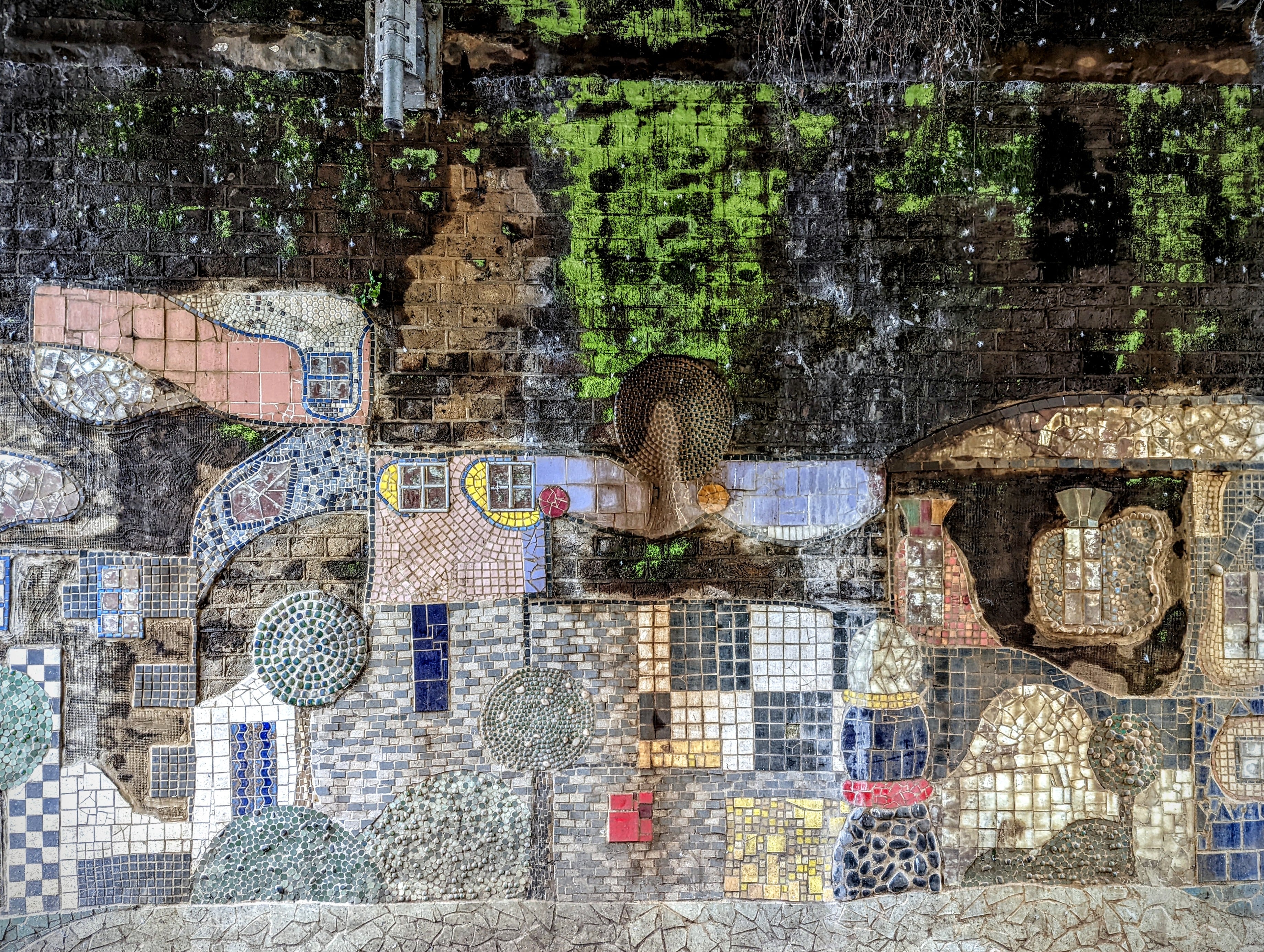 Overhead view of colorful mosaic tile floor with blues, whites, yellows, and browns