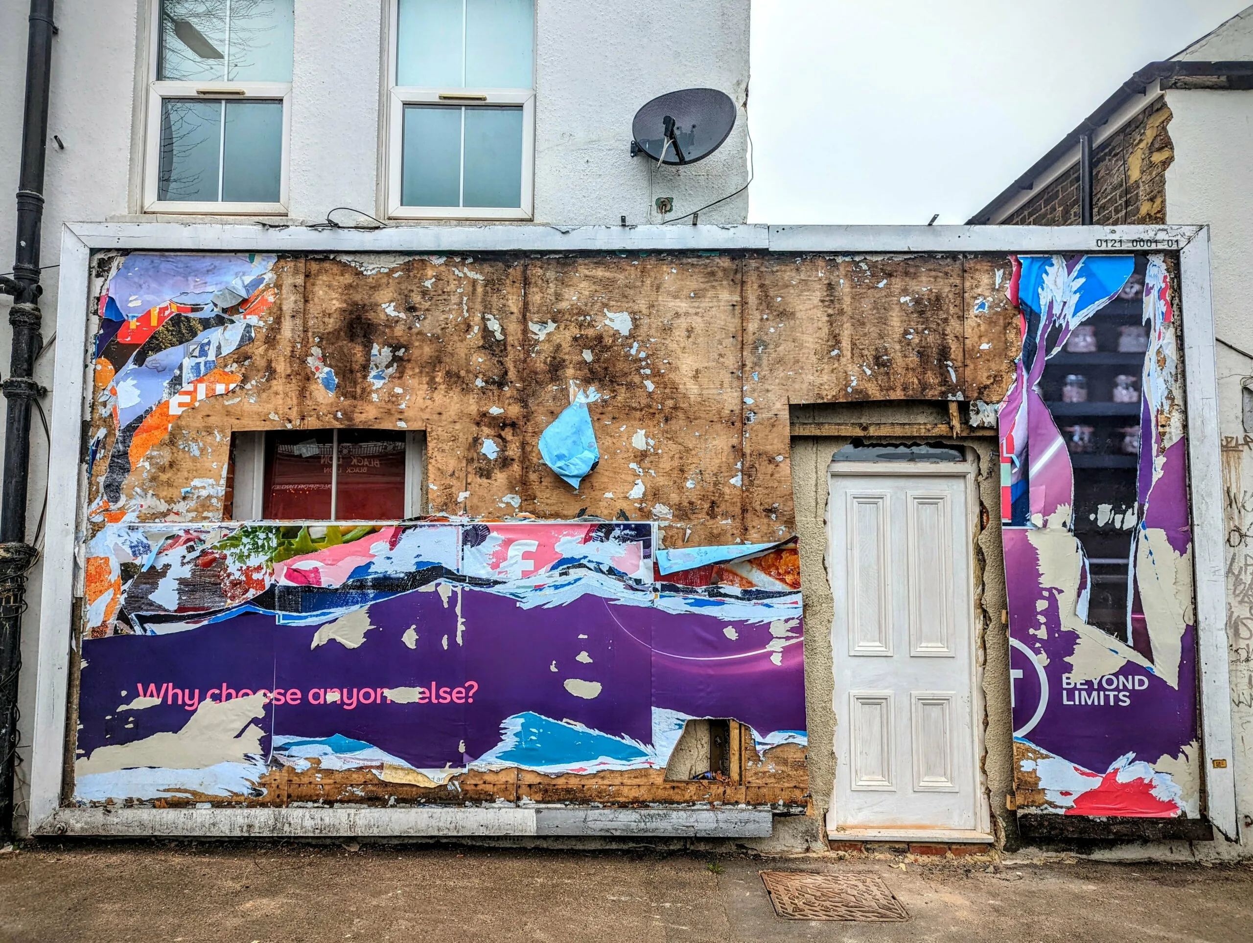 Colorful graffiti art on weathered building facade with text and geometric shapes