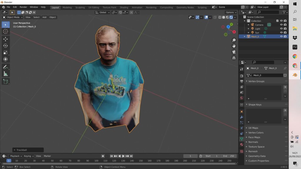 Blender interface showing a 3D scan of a man in a turquoise t-shirt. The selected object, Mesh_0, is displayed in the 3D viewport and outliner.