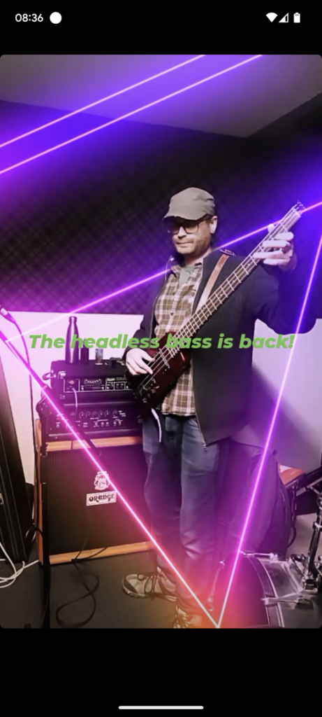Screenshot of a man in a music studio holding a headless bass guitar, featuring neon purple line overlays and green text: "The headless bass is back!