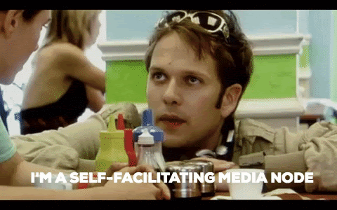 Self-Facilitating Media Node Gif - Nathan Barley in a cafe with the text: I'M A SELF-FACILITATING MEDIA NODE