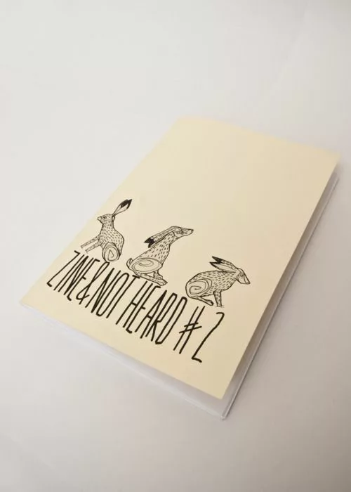 Cream-colored zine titled ZINE & NOT HEARD #2 with black ink illustrations of three hares in different poses on a white background.
