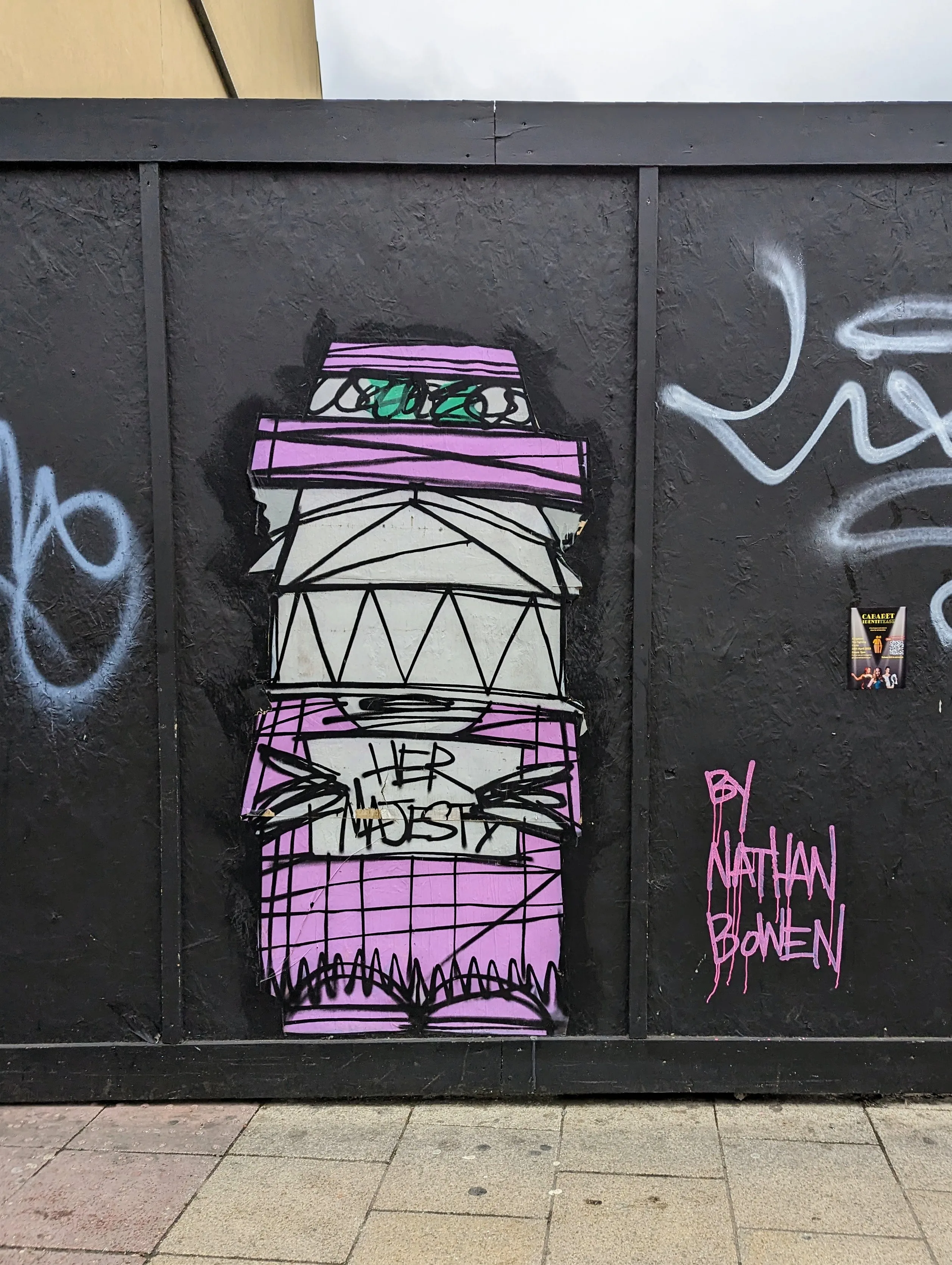Nathan Bowen street art on a black hoarding of a stylized purple figure holding a sign that reads HER MAJESTY.