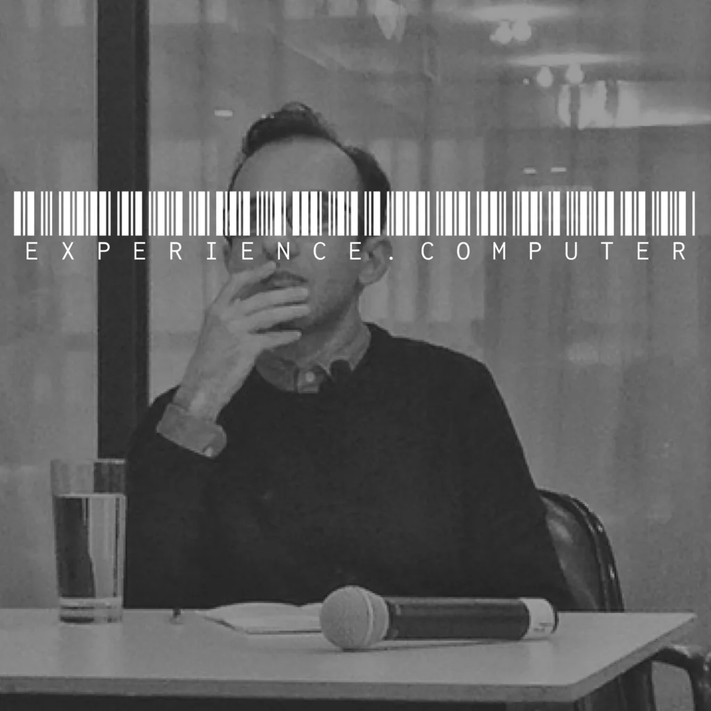 experience.computer podcast cover - a black and white photo of guest Reza Negarestani with a white barcode and the text E X P E R I E N C E . C O M P U T E R overlaid across his eyes.
