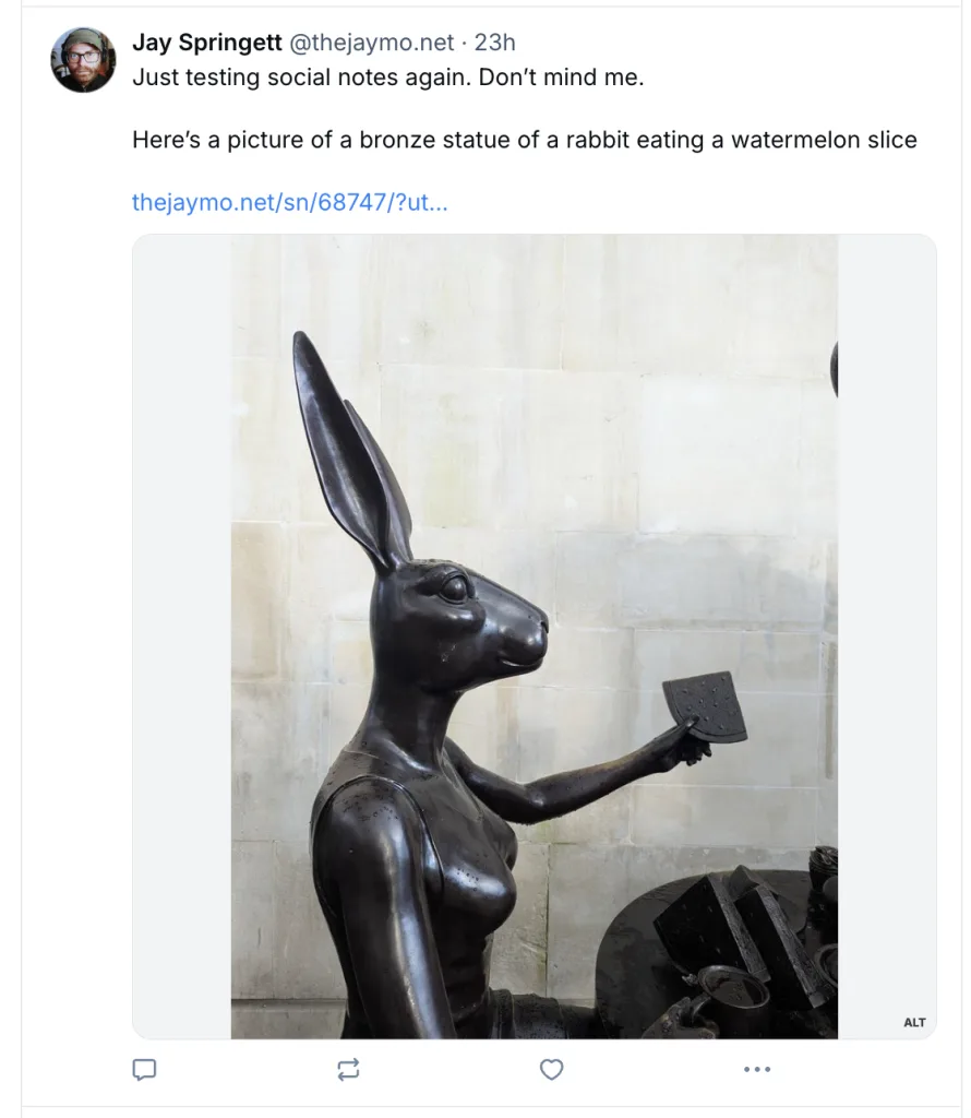 Screenshot of a social media post by Jay Springett (@thejaymo.net) that reads: "Just testing social notes again. Don’t mind me. Here’s a picture of a bronze statue of a rabbit eating a watermelon slice". Below the text is an image of a dark bronze statue depicting an anthropomorphic rabbit holding a slice of watermelon.