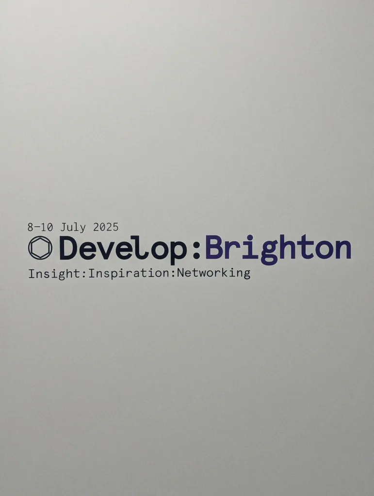 Develop:Brighton conference signage on a plain wall for 8-10 July 2025 with the tagline Insight:Inspiration:Networking