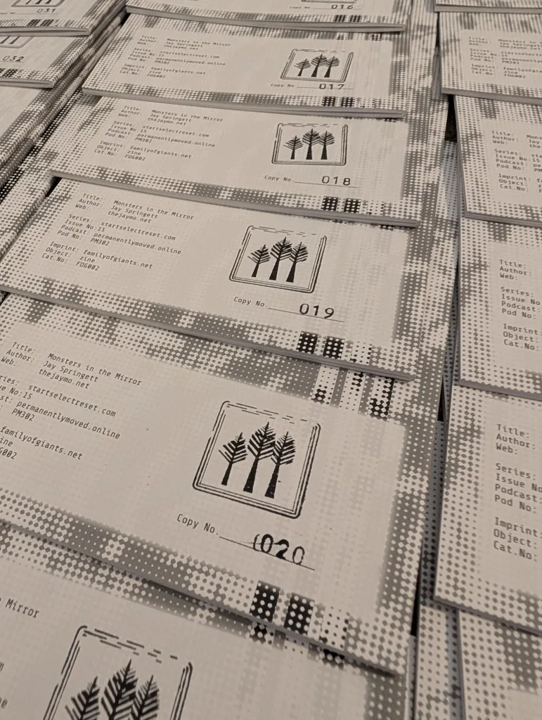 Numbered copies of Jay Springett's zine, Monsters in the Mirror, showing copies 017 to 020 with a black graphic of three trees on the front.