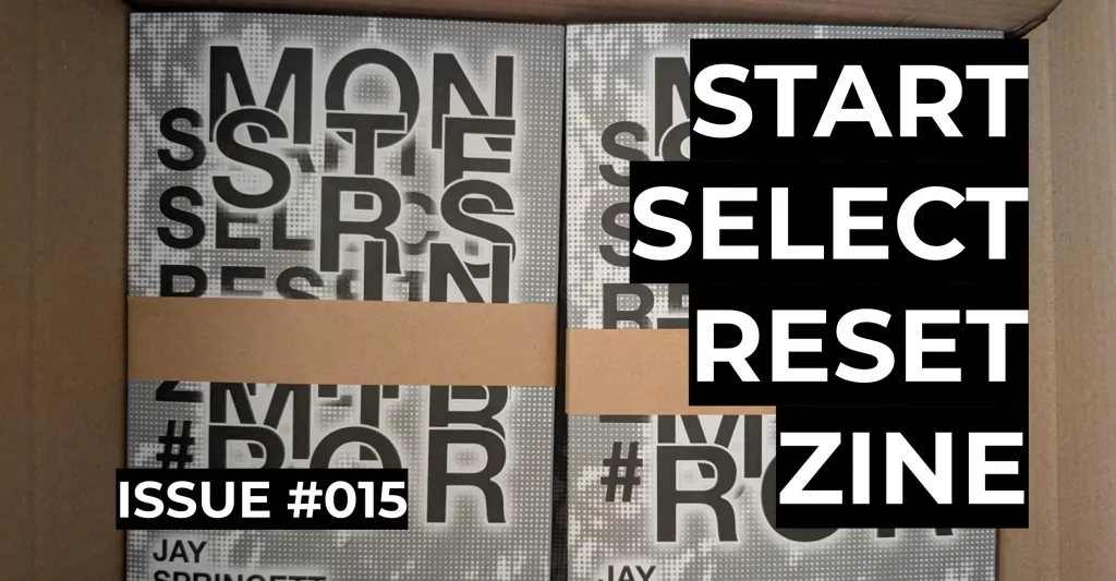 Featured image for Start Select Reset Zine Issue #015 - Two physical copies of the zine in a cardboard box with bold text overlays.